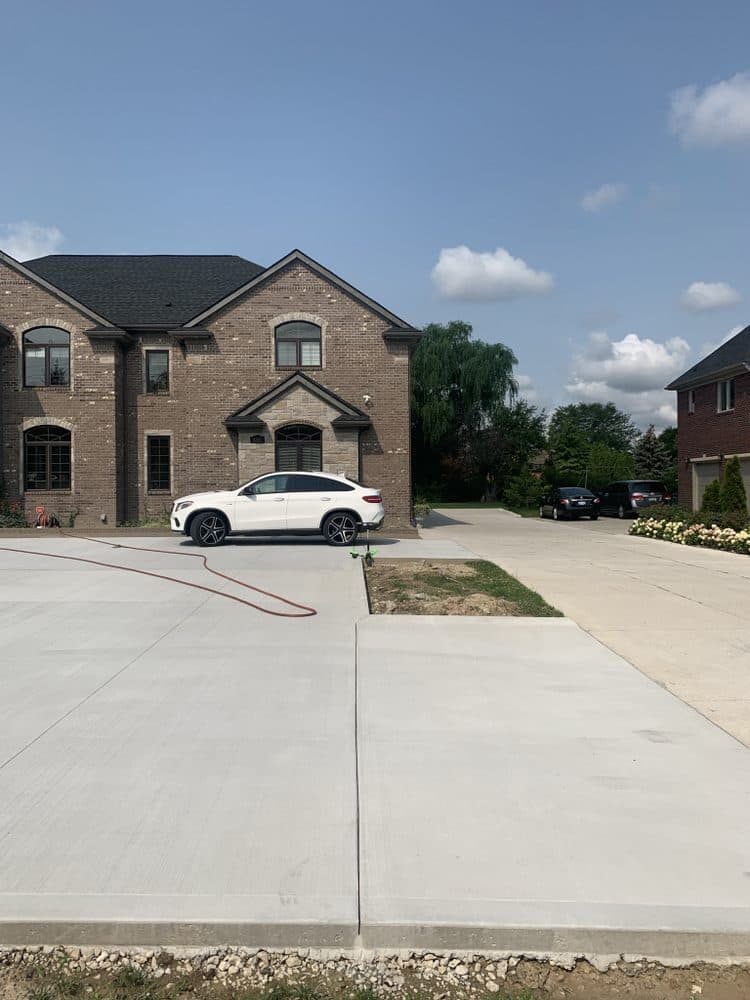 New poured concrete driveway at a brick home in Metro Detroit