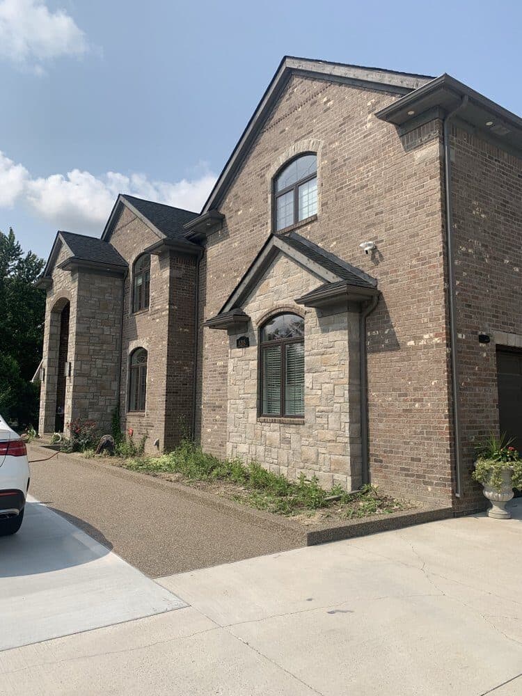Concrete driveway with new hedging and lawn