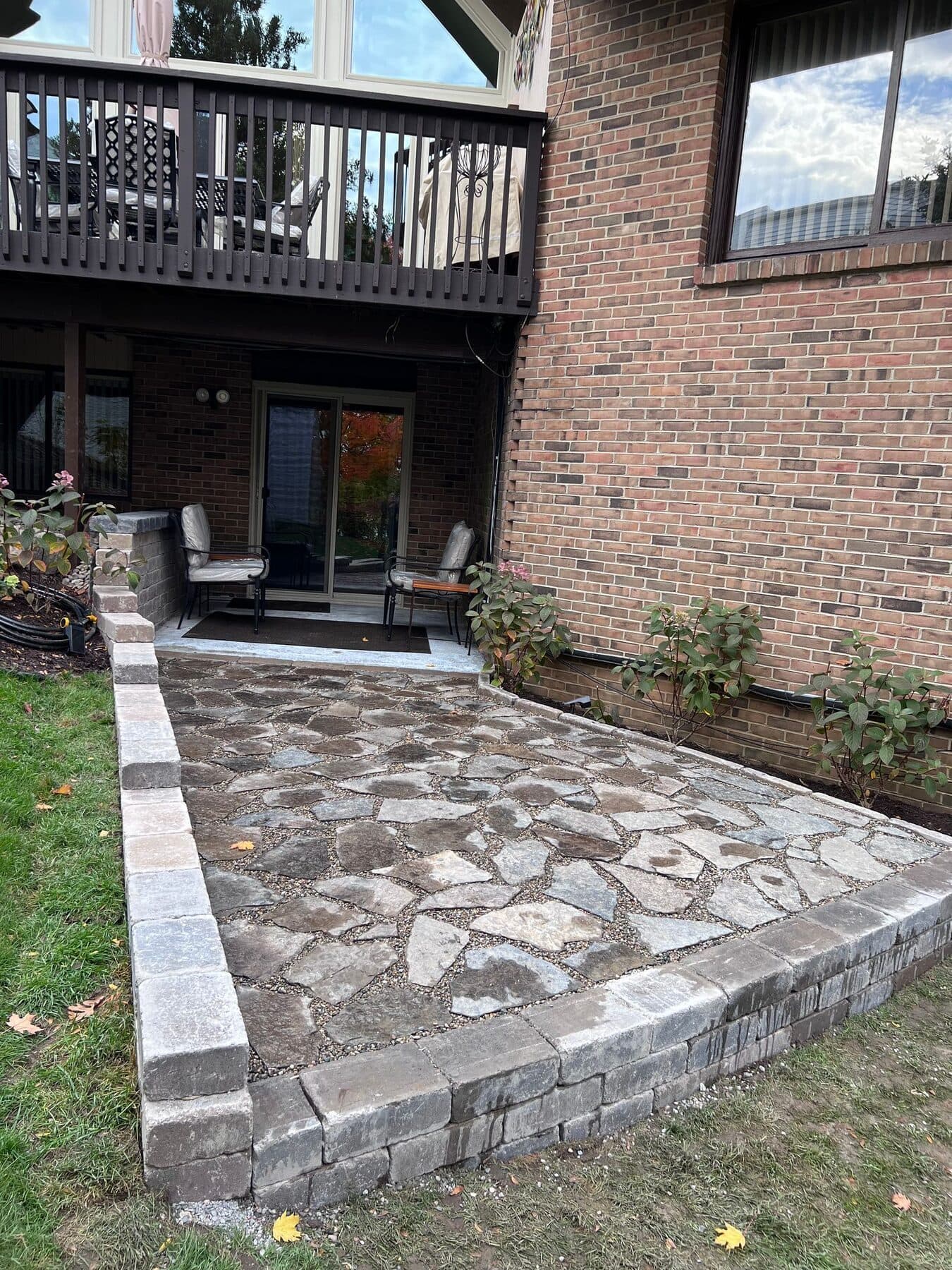 Finished flagstone patio with a built seat wall