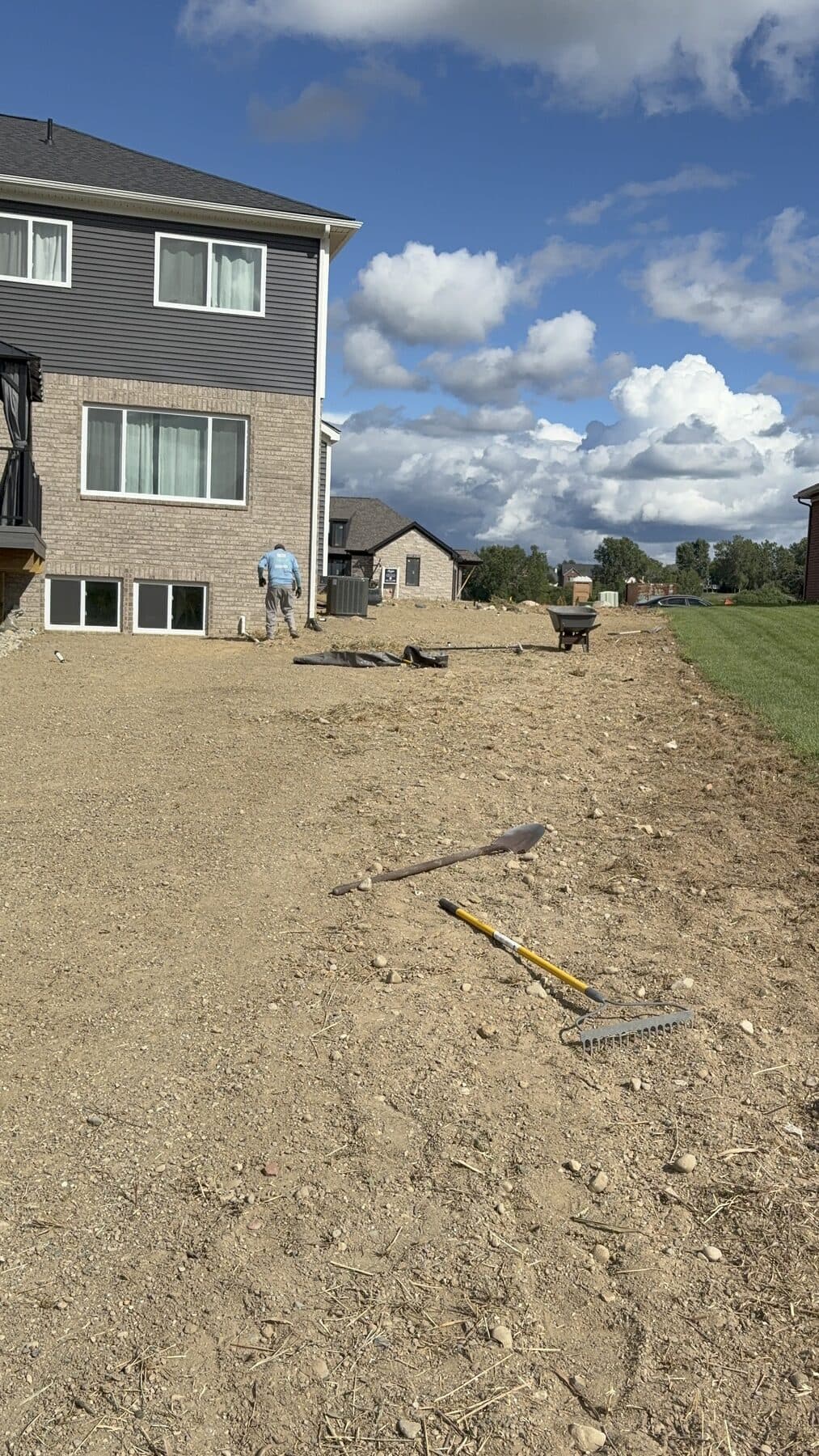 A new build back yard graded out to bare dirt, crew at work