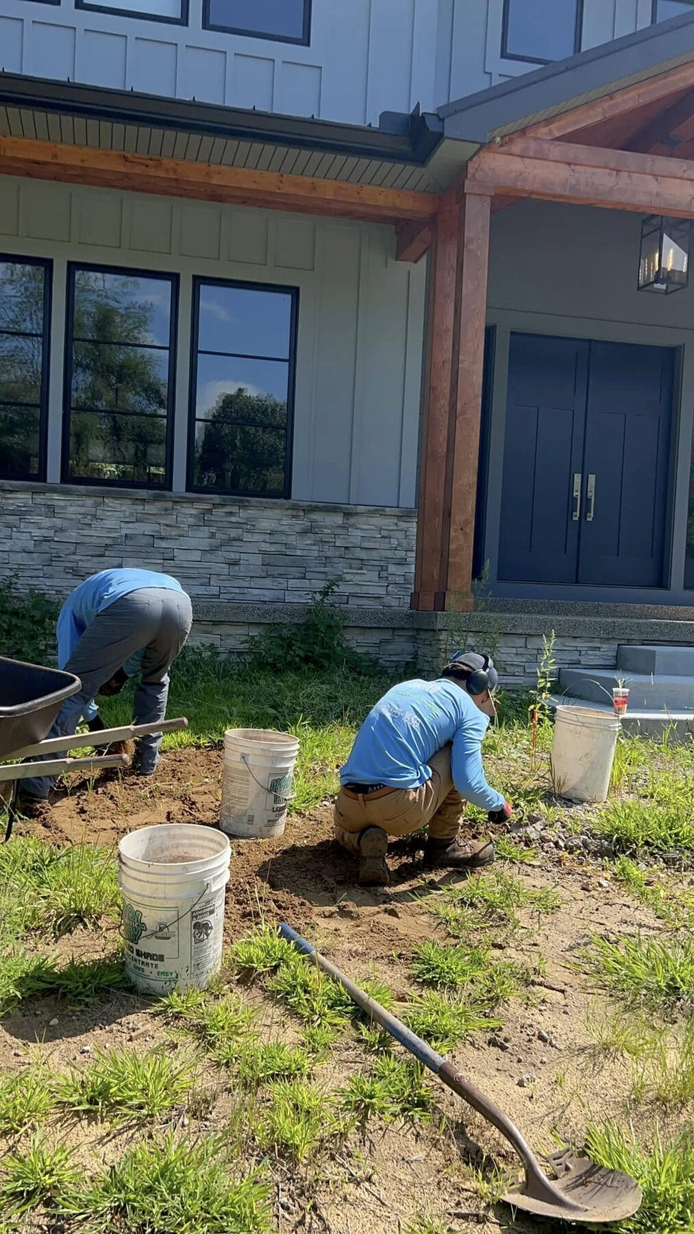 Trusted Landscaping crew planting new beds at a new-build home